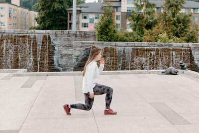 woman lunging on the sidewalk