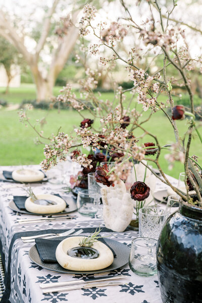 Detail-driven wedding reception table with organic floral centerpieces