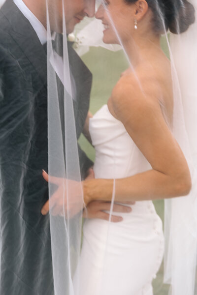 A documentary photo of a couple under the brides veil at Spring grove Ranch in Appomattox Virginia
