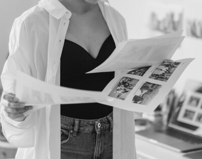 Featured image of woman holding papers at a branding agency studio for copywriting services for Pinterest virtual assistants,photographers, course creators, small business owners, and more creatives.