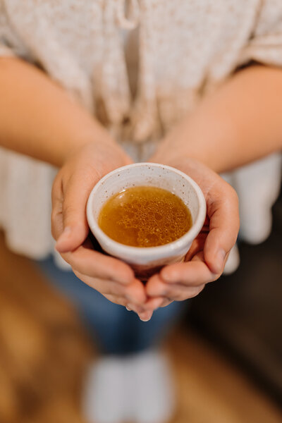 Kenna holding a bowl of bone broth