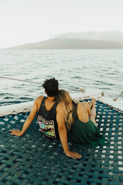 couple sitting next to water