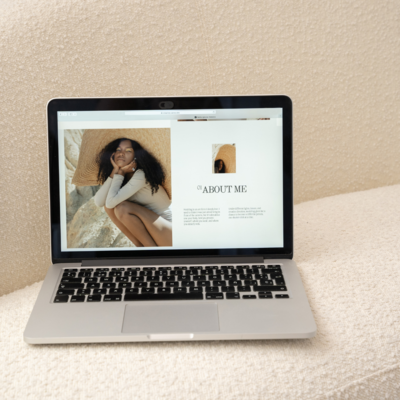 Computer laptop with a woman on it and it says "about me."