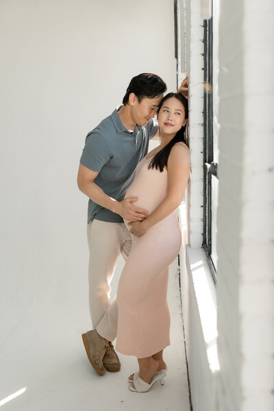 Pregnant woman and husband posing together