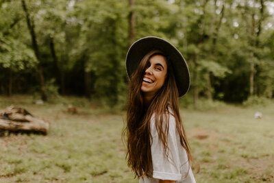 woman wearing a hat and smiling