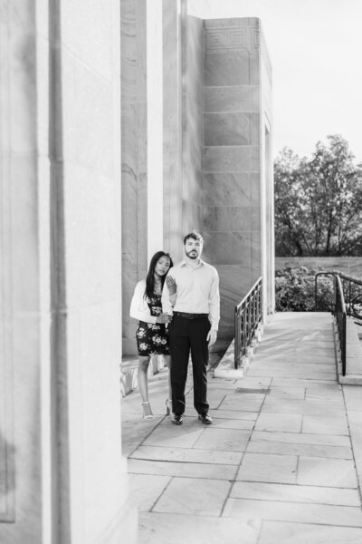 An engaged couple pose on the patio of the Ohio Supreme Court building