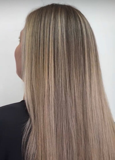 Image of client with dark blonde full highlights.