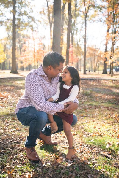 Dad and daughter on knee