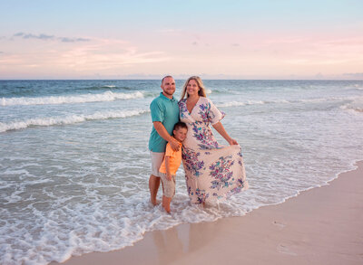 mom-dad-and-son-posing-in-water-on-navarre-beach