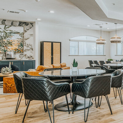 Chic community lounge at Westwood Bluffs Apartments in Fresno, CA featuring modern decor, leather seating, and natural accents.