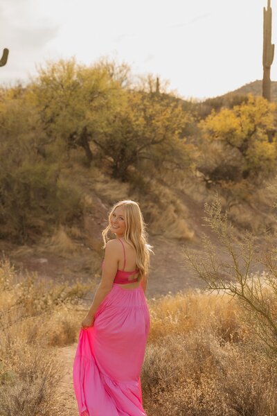 girl poses in arizona desert for senior pictures