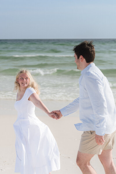 Couple gets engaged after a proposal on the beach in Seaside, Florida