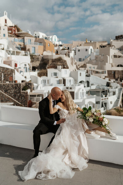 An adventure elopement in Santorini with cliffside picnic at sunset