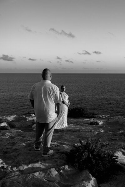 a man and woman getting married at the Blue Grotto in Malta on the cliffside in the Fall time