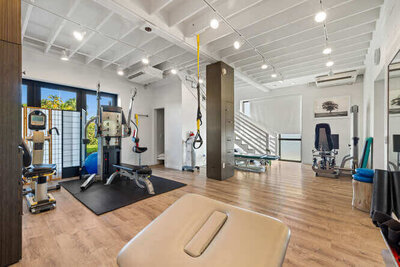 Private PT session area with treatment table and rehabilitation tools