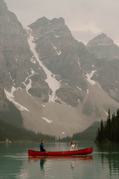 banff elopement photographer takes couple canoeing on mountain lake