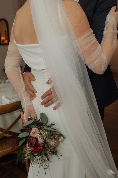 back of brides dress with bouquet by 5th Street Floral in Courtenay by Latitude 49 photography