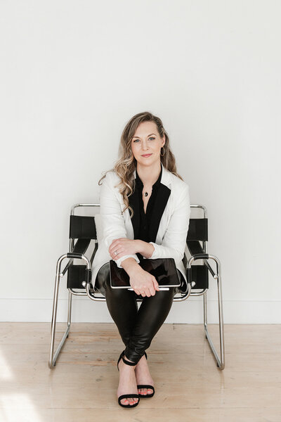 erika-owner-of-creatively-social-co-sitting-holding-an-ipad
