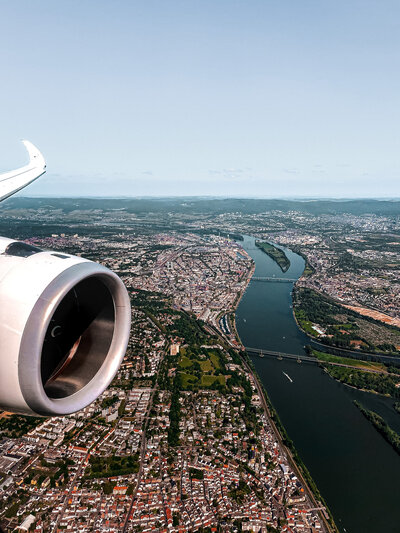 View outside an airplane window an airplane airel and that city below