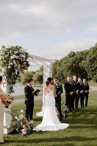 A couple standing up saying their vows during their wedding 