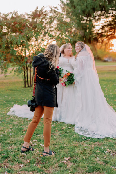 Nikki takes a photo of a newlywed couple.