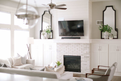 White-black-neutral-living-room-fireplace-tv-couch-custom-interior-design-LT-Design-Co-Iowa