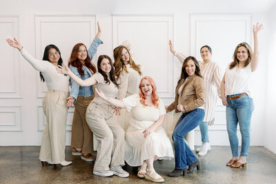 Stylist team posing with their arms out