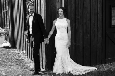 Bride and groom hold hands while waiting for first look at their CHQ Barn wedding