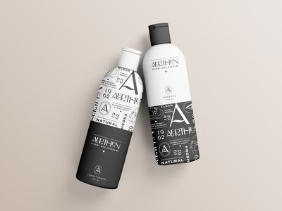 Two hair shampoo and conditioner bottles showcase the luxury branding and packaging design for Aerthen, a clean, vegan beauty brand.