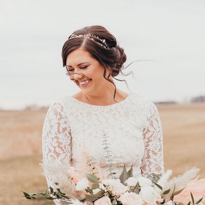 bride holding bouquet and smiling
