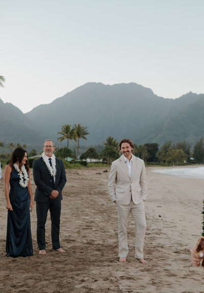 groom on beach in kauai at Hanalei Bay