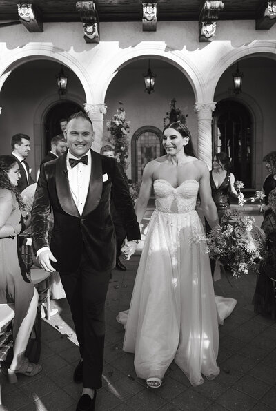 A stunningly colorful wedding ceremony at The Powel Crosley Estate in Sarasota, Florida—Watters & Co. Events curates an elevated guest experience with lush floral installations and sophisticated design.