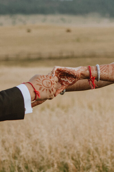 couple with henna holds hands