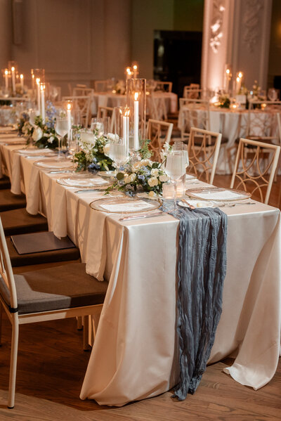 Chic wedding table decor with white and green floral centerpieces by Leigh Florist, perfectly complementing the elegant reception setup.
