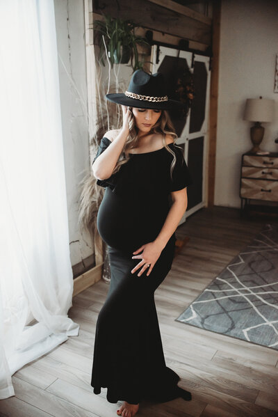 Bringing a little glamour and sass to her maternity session a momma captures her twin belly with some gold accents. 
