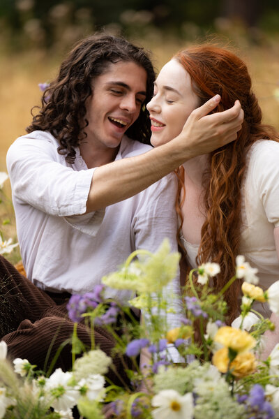 A person reaching their hand around their partner's head
