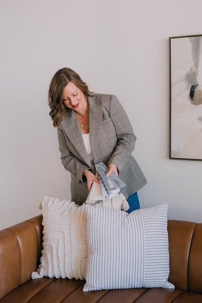 Katie from Modern Mollusk arranging decor during an occupied home staging project in Snohomish County.