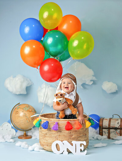 This kiddo had a blast at his denver childrens photography session with his hot air balloon set up.