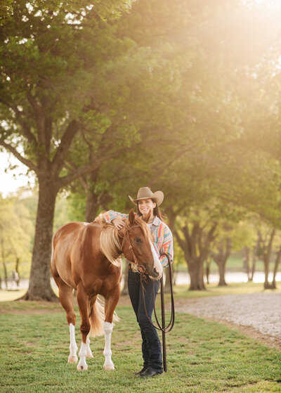 blonde girl posing with sports horse