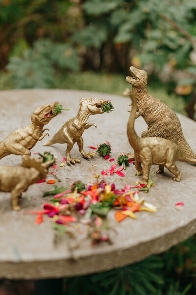 wedding detail shot of dinosaurs eating wedding florals at reception in Seattle, WA. 