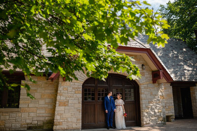 Bride and groom in front of garage at The Grove Redfield Estate in Glenview, IL