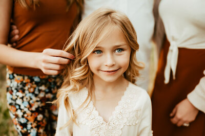 tween with pretty blond hair smiling.