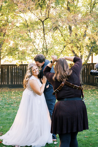 megan helm photographing bride and groom at sunset