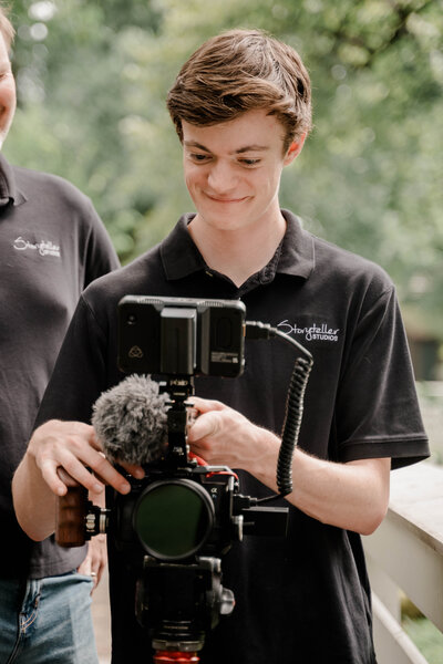video producer eli ommen operates  a camera on location in an historic neighborhood