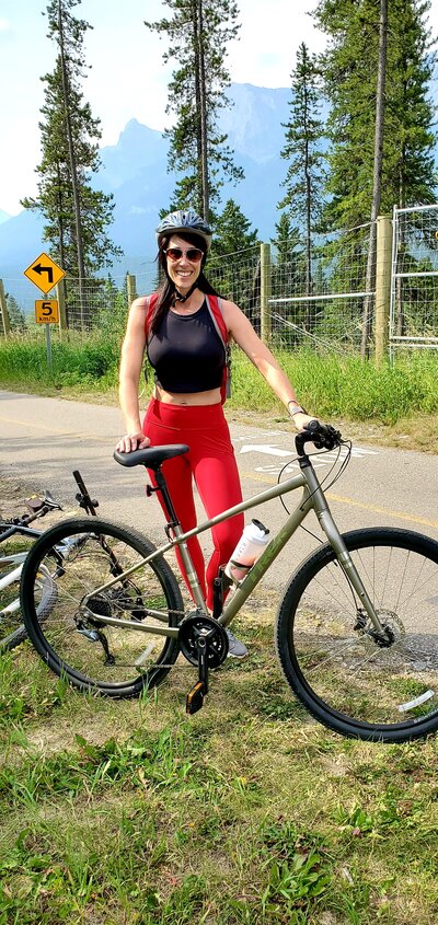 Female with bicycle wearing helmet