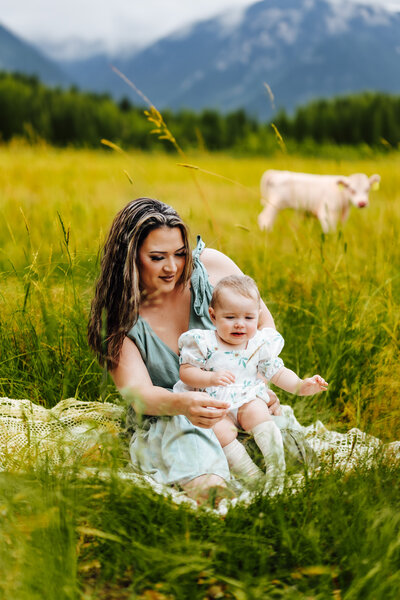 Mother and daughter sitting in the grass
