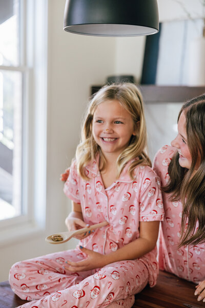 Mom hugging daughter with both laughing.