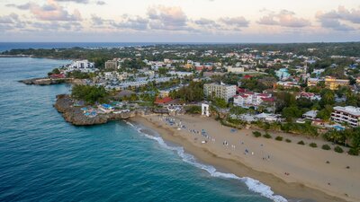 Aerial photo of the Dominican shoreline with beaches, umbrellas, and turquoise water