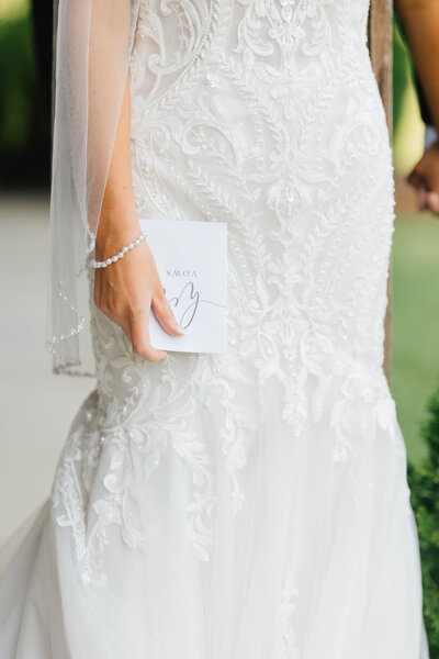 close up of the white lace on a bride's wedding dress