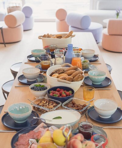 Delicious breakfast spread with fresh pastries, fruit, and coffee, perfect for starting a day of adventure in the Alps. Explore more at TheCampusAlps.com